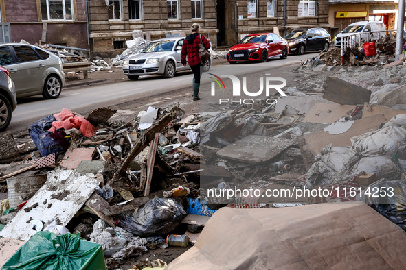 A woman walks pass debris from destroyed  buildings as massive flooding affected tourist resorts in southern Poland - Klodzko, Poland on Sep...