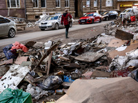 A woman walks pass debris from destroyed  buildings as massive flooding affected tourist resorts in southern Poland - Klodzko, Poland on Sep...