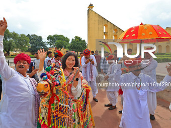 Rajasthani folk artists perform with tourists during the World Tourism Day celebration at the historical Jantar Mantar in Jaipur, Rajasthan,...