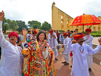 Rajasthani folk artists perform with tourists during the World Tourism Day celebration at the historical Jantar Mantar in Jaipur, Rajasthan,...