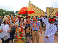 Rajasthani folk artists perform with tourists during the World Tourism Day celebration at the historical Jantar Mantar in Jaipur, Rajasthan,...