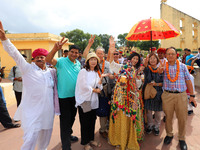 Rajasthani folk artists perform with tourists during the World Tourism Day celebration at the historical Jantar Mantar in Jaipur, Rajasthan,...