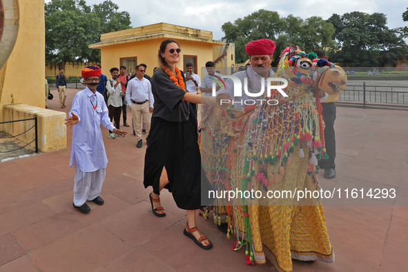 Rajasthani folk artists perform with tourists during the World Tourism Day celebration at the historical Jantar Mantar in Jaipur, Rajasthan,...