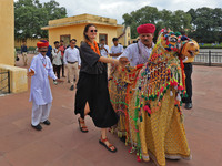 Rajasthani folk artists perform with tourists during the World Tourism Day celebration at the historical Jantar Mantar in Jaipur, Rajasthan,...