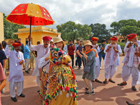 Rajasthani folk artists perform with tourists during the World Tourism Day celebration at the historical Jantar Mantar in Jaipur, Rajasthan,...