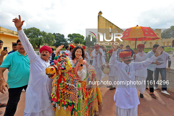 Rajasthani folk artists perform with tourists during the World Tourism Day celebration at the historical Jantar Mantar in Jaipur, Rajasthan,...