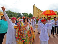 Rajasthani folk artists perform with tourists during the World Tourism Day celebration at the historical Jantar Mantar in Jaipur, Rajasthan,...