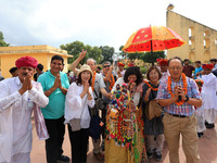 Rajasthani folk artists perform with tourists during the World Tourism Day celebration at the historical Jantar Mantar in Jaipur, Rajasthan,...