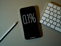 Interest rate percentage is seen on a phone screen in this illustration photo taken in Warsaw, Poland on 27 September, 2024. (