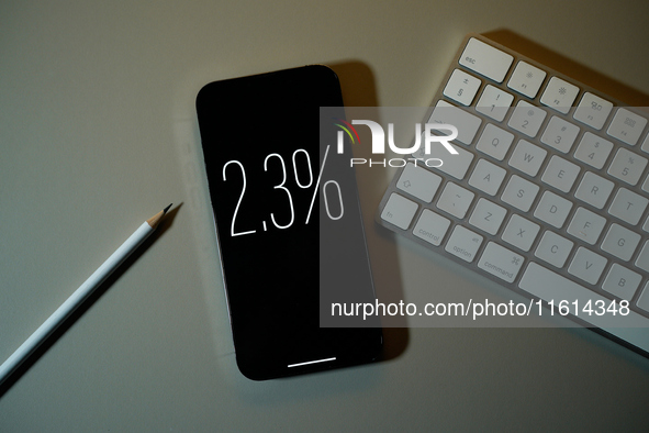 Interest rate percentage is seen on a phone screen in this illustration photo taken in Warsaw, Poland on 27 September, 2024. 