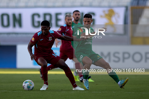 Luis Carlo Riascos (left) of Gzira United is followed by Nicolas Marias Garcia (right) of Floriana during the Malta 360 Sports Premier Leagu...