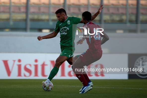 Jake Grech of Floriana (left) is about to shoot at goal during the Malta 360 Sports Premier League soccer match between Floriana and Gzira U...