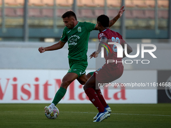 Jake Grech of Floriana (left) is about to shoot at goal during the Malta 360 Sports Premier League soccer match between Floriana and Gzira U...