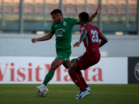 Jake Grech of Floriana (left) is about to shoot at goal during the Malta 360 Sports Premier League soccer match between Floriana and Gzira U...