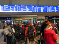 Travelers wait in line in front of the train information desk at Cologne Central Station due to construction work. Cologne Central Station c...