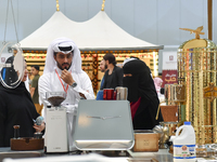 An exhibitor introduces products to visitors at the 2024 Doha International Coffee Exhibition at Doha Exhibition and Convention Center in Do...