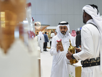 Visitors look at new coffee products during the 2024 Doha International Coffee Exhibition at Doha Exhibition and Convention Center in Doha,...