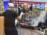 An exhibitor prepares coffee at the 2024 Doha International Coffee Exhibition at Doha Exhibition and Convention Center in Doha, Qatar, on Se...