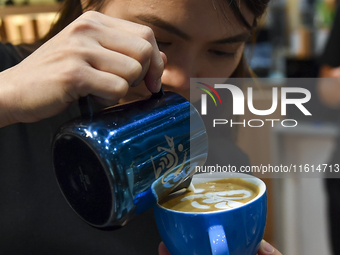 An exhibitor prepares coffee at the 2024 Doha International Coffee Exhibition at Doha Exhibition and Convention Center in Doha, Qatar, on Se...