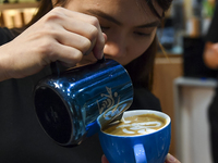 An exhibitor prepares coffee at the 2024 Doha International Coffee Exhibition at Doha Exhibition and Convention Center in Doha, Qatar, on Se...