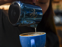 An exhibitor prepares coffee at the 2024 Doha International Coffee Exhibition at Doha Exhibition and Convention Center in Doha, Qatar, on Se...