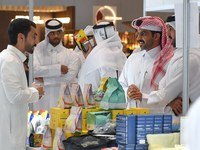 Visitors watch coffee products at a booth during the 2024 Doha International Coffee Exhibition at Doha Exhibition and Convention Center in D...