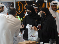 Visitors watch coffee products at a booth during the 2024 Doha International Coffee Exhibition at Doha Exhibition and Convention Center in D...