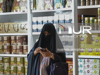 A visitor looks at coffee products during the 2024 Doha International Coffee Exhibition at Doha Exhibition and Convention Center in Doha, Qa...