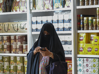 A visitor looks at coffee products during the 2024 Doha International Coffee Exhibition at Doha Exhibition and Convention Center in Doha, Qa...