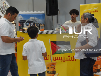 People visit the Palestinian coffee booth during the 2024 Doha International Coffee Exhibition at Doha Exhibition and Convention Center in D...