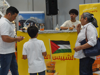 People visit the Palestinian coffee booth during the 2024 Doha International Coffee Exhibition at Doha Exhibition and Convention Center in D...