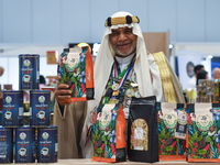 A Saudi Arabian exhibitor shows coffee products at a booth during the 2024 Doha International Coffee Exhibition at Doha Exhibition and Conve...