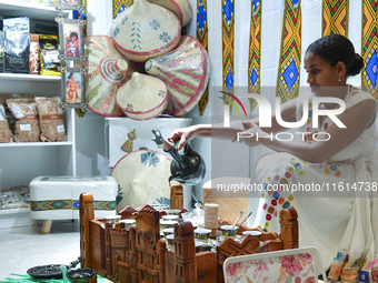 An exhibitor prepares Ethiopian coffee at an exhibition during the 2024 Doha International Coffee Exhibition at Doha Exhibition and Conventi...