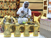 A Qatari man prepares traditional Qatari Arabic coffee during the 2024 Doha International Coffee Exhibition at Doha Exhibition and Conventio...