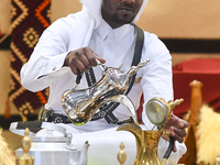 A Qatari man prepares traditional Qatari Arabic coffee during the 2024 Doha International Coffee Exhibition at Doha Exhibition and Conventio...