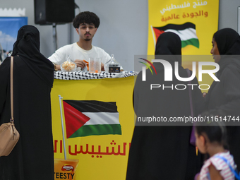 People visit the Palestinian coffee booth during the 2024 Doha International Coffee Exhibition at Doha Exhibition and Convention Center in D...