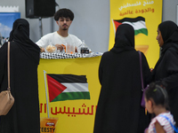 People visit the Palestinian coffee booth during the 2024 Doha International Coffee Exhibition at Doha Exhibition and Convention Center in D...