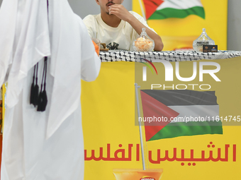 People visit the Palestinian coffee booth during the 2024 Doha International Coffee Exhibition at Doha Exhibition and Convention Center in D...