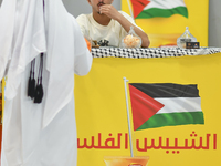 People visit the Palestinian coffee booth during the 2024 Doha International Coffee Exhibition at Doha Exhibition and Convention Center in D...