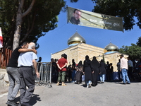 Lebanese clerics pray over the coffins of 16 people, including three Hezbollah militants, who are killed in an Israeli airstrike on the vill...