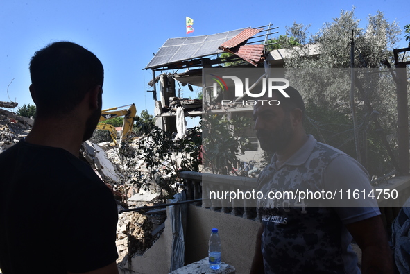 Lebanese clerics pray over the coffins of 16 people, including three Hezbollah militants, who are killed in an Israeli airstrike on the vill...