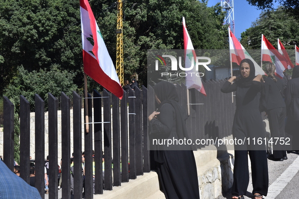 Lebanese clerics pray over the coffins of 16 people, including three Hezbollah militants, who are killed in an Israeli airstrike on the vill...