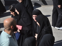 Lebanese clerics pray over the coffins of 16 people, including three Hezbollah militants, who are killed in an Israeli airstrike on the vill...