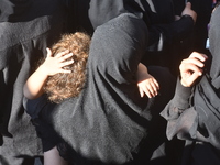 Lebanese clerics pray over the coffins of 16 people, including three Hezbollah militants, who are killed in an Israeli airstrike on the vill...