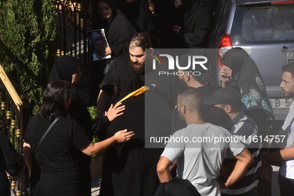 Lebanese clerics pray over the coffins of 16 people, including three Hezbollah militants, who are killed in an Israeli airstrike on the vill...