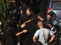 Lebanese clerics pray over the coffins of 16 people, including three Hezbollah militants, who are killed in an Israeli airstrike on the vill...