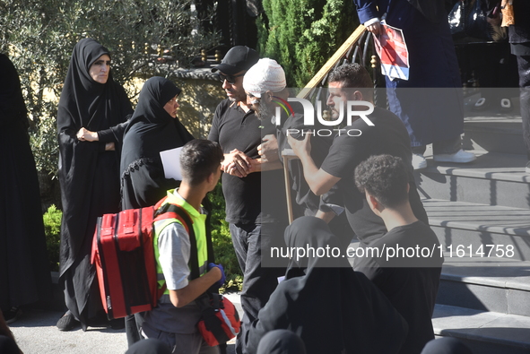 Lebanese clerics pray over the coffins of 16 people, including three Hezbollah militants, who are killed in an Israeli airstrike on the vill...