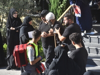 Lebanese clerics pray over the coffins of 16 people, including three Hezbollah militants, who are killed in an Israeli airstrike on the vill...