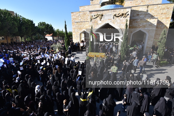 Lebanese clerics pray over the coffins of 16 people, including three Hezbollah militants, who are killed in an Israeli airstrike on the vill...