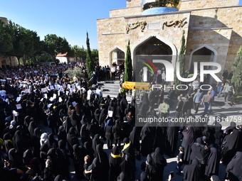 Lebanese clerics pray over the coffins of 16 people, including three Hezbollah militants, who are killed in an Israeli airstrike on the vill...